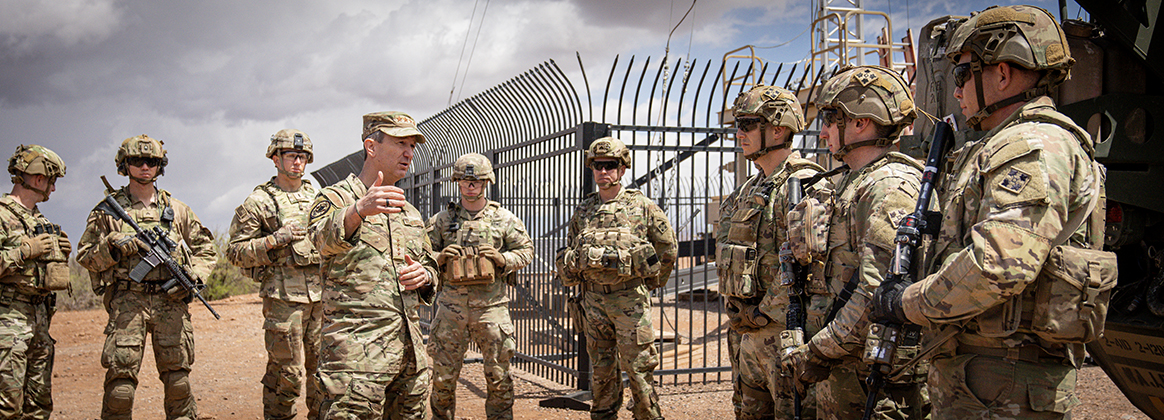 soldiers in uniform with guns standing